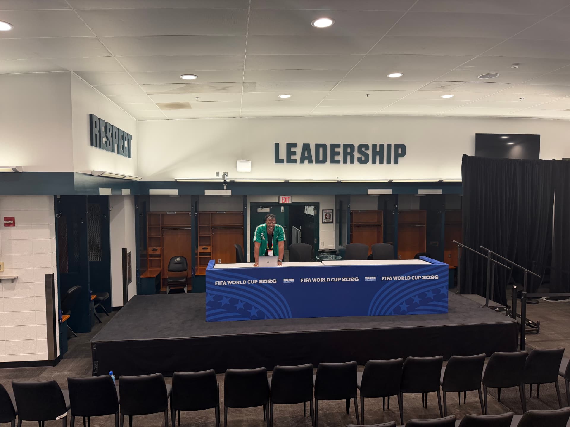Brian Gibbs behind the FIFA World Cup 2026 press conference desk in the completed media room at Lincoln Financial Field.